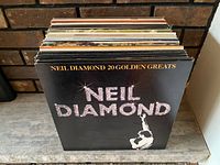 Stack of vinyl records fronted by Neil Diamond 20 Golden Greats