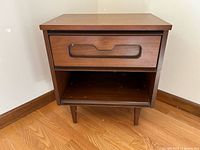Front view of nightstand showing drawer, open shelf and tapered legs