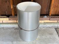 Full view of rolled metal flashing standing upright with tie cord