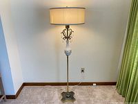 Full view of vintage tri-lite floor lamp showing ceramic center, prisms, brass base, and drum shade
