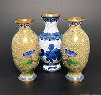 Front view of all three vases displaying color and patterns