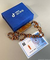 Blue box, necklace, certificate card overview