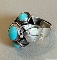 Front view showing turquoise stones and leaf design