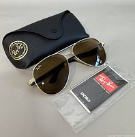 Sunglasses, case, leaflet together