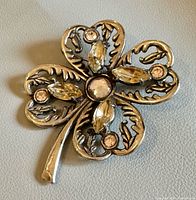 Front view showing clover shape and rhinestones