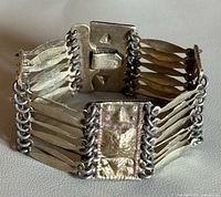 Bracelet fastened showing side profile, slide clasp visible