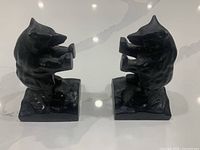 front view of both cast iron bear bookends on countertop