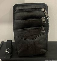 Front view showing zip compartments and texture