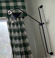 Sconce installed on wall showing long arm and shade