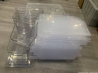 Stacked clear bins and lids viewed from side