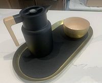 Top view of thermal carafe on leather tray with matcha bowl
