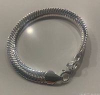 Bracelet coiled to show thickness and clasp