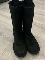 Front view of black UGG tall boots pair