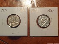Both 1951 Canadian nickels in holders, commemorative left, beaver right