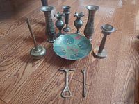 Group shot showing all brass vases, bowl, candlestick, and utensils