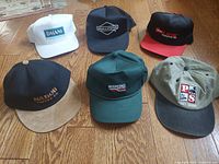 All six caps arranged on floor