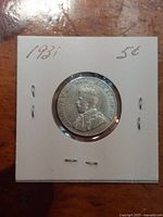 Obverse view of 1931 George V nickel in holder