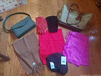 Overview of both handbags, three scarves, three pairs of gloves, and toque
