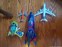 Group shot of all four toys on wood floor