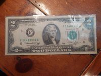 Full view of obverse of 1976 $2 bill in sleeve