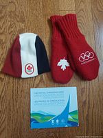 Toque, mittens pair and coin set folder laid out together