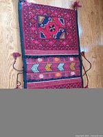 Close view of one pouch panel with geometric star motif and tasselled edges