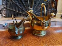Large and small brass coal scuttles side by side