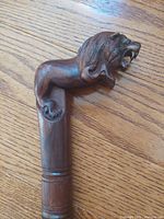 Close-up of carved lion handle and upper shaft