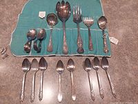 Overall group of flatware in wrap and loose pieces