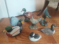 Group shot of all seven bird figurines on floor