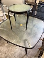 Both tables shown together, small round table placed atop larger rectangular table