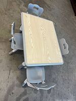 Top view of rectangular children’s table with four chairs around