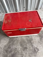 Top view of closed red metal Coleman cooler