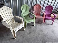 Four plastic Adirondack chairs lined up showing color variety and overall condition