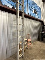 Full view of Keller aluminum extension ladder leaning against wall