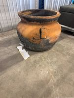 Front view of terracotta planter showing overall shape and weathered patina