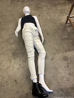 Full mannequin lying flat wearing clothing and boot