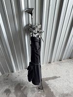 Full view of black stand bag with clubs inserted