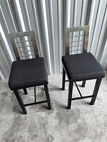 Front view showing both stools, frames, seats, backrests