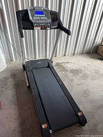 Full view of treadmill from front right showing deck and console