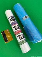 White vinyl roll, blue 3M roll, squeegee, size-reference card