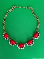 Full view of necklace laid flat showing entire design and chain