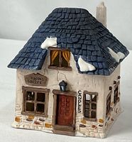 Front view of porcelain building showing signs, door and windows