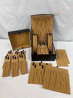 Complete set: case, slipcover, pads, trays, earring cards