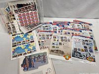 Overview of bin with assorted stamp sheets and first day cover