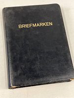 Closed black album cover with gold title