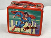 Front view showing Superman flying over skyline graphic