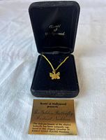 Necklace in open branded box with info card