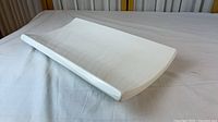 Top angled view of curved white ceramic platter