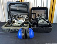 Overall lot showing both tools in open cases and ear-muffs